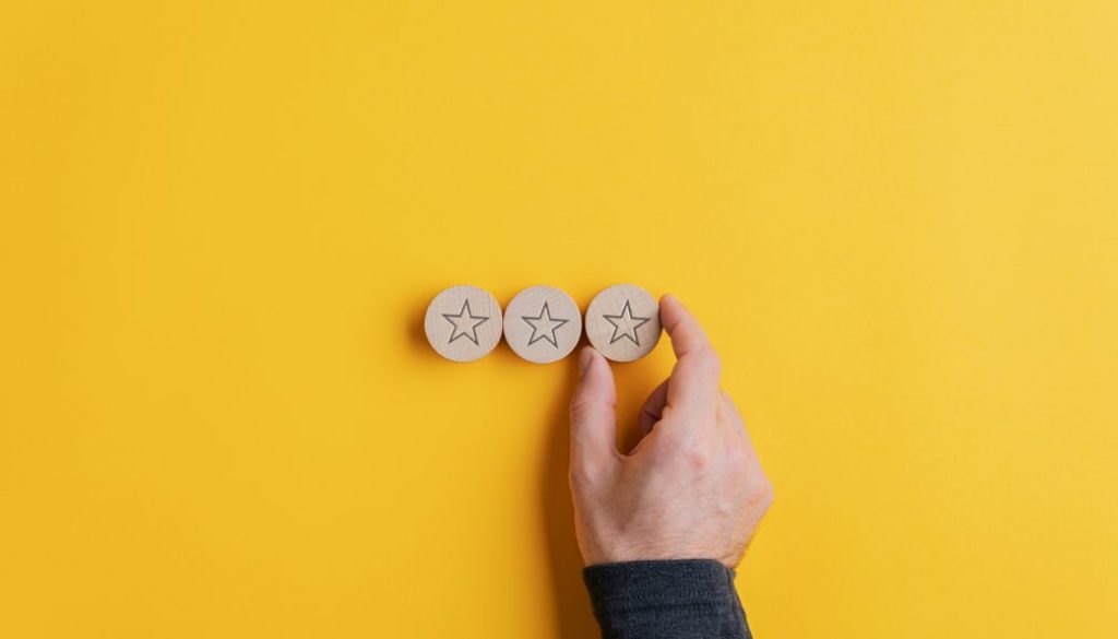 Placing three wooden cut circles with star shape on them in a row
