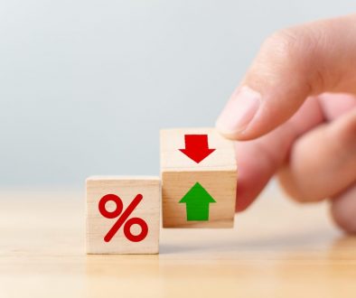 Interest rate financial and mortgage rates concept. Hand flip wood cube change arrow down to up