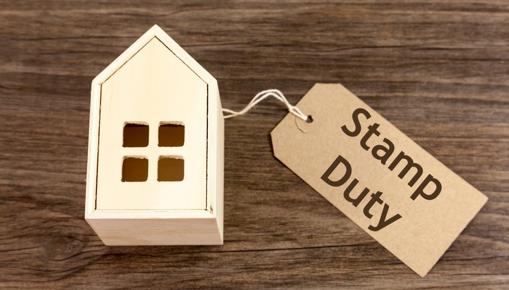 Wooden house with label attached which reads 'Stamp Duty'