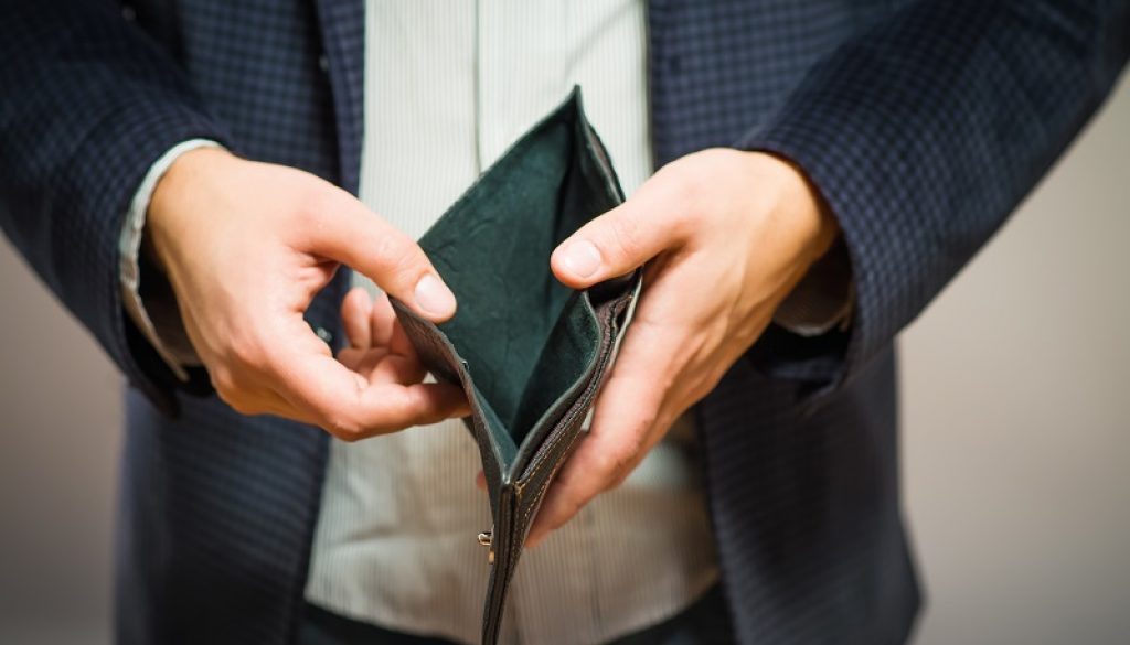 Bankruptcy - Business Person holding an empty wallet