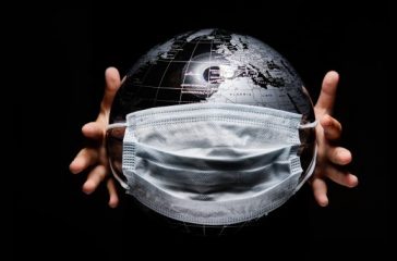Kid holding globe map sphere isolated on black horizontal background. Ecological problems disasters. COVID-19 pandemic infection disease concept image, copy space for text