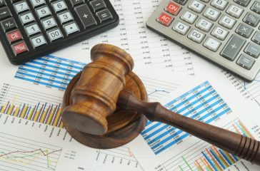 Arbitration concept, judge gavel and calculators on financial documents
