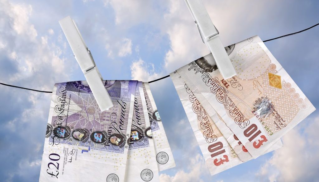 UK pounds dry on washing line pegs- financial metaphor