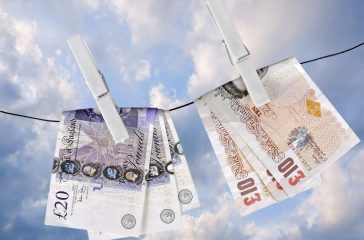 UK pounds dry on washing line pegs- financial metaphor