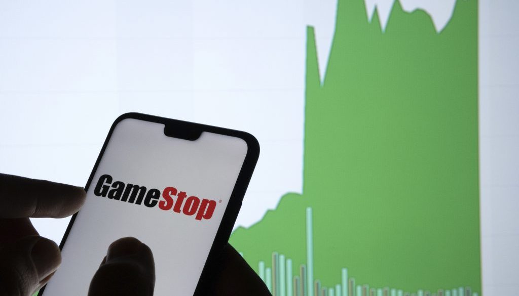 Gamestop retail company logo on the smartphone and its authentic stock price chart for the last 5 days. Stafford, United Kingdom - January 27 2021.