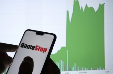 Gamestop retail company logo on the smartphone and its authentic stock price chart for the last 5 days. Stafford, United Kingdom - January 27 2021.