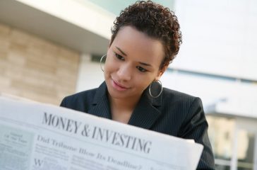 A african american business woman with newspaper