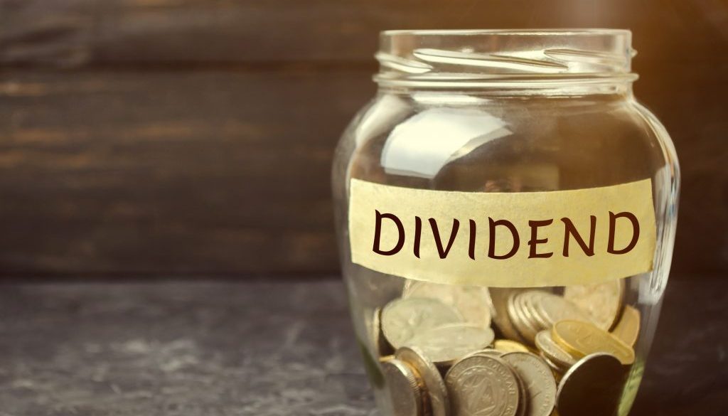 Glass jar with the word Dividend. A dividend is a payment made by a corporation to its shareholders as a distribution of profits. Concept business finance and investment. Saving money. Dividend tax