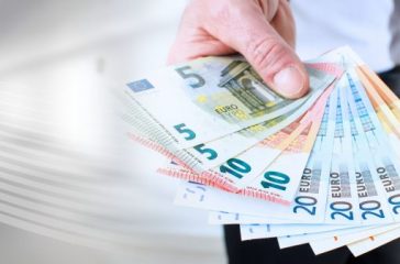 Man hand holding euro notes; panoramic banner