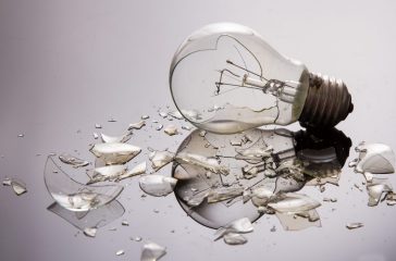 Broken light bulb on shiny surface