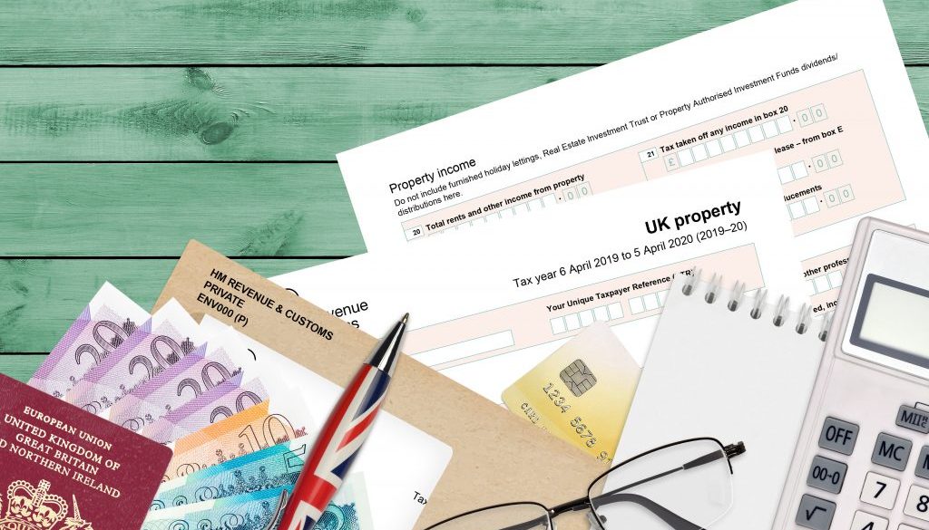 English Tax form sa105 UK Property from HM revenue and customs lies on table with office items. HMRC paperwork and tax paying process in United Kingdom
