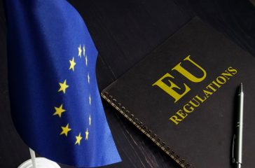 EU regulations and Europe Union flag.