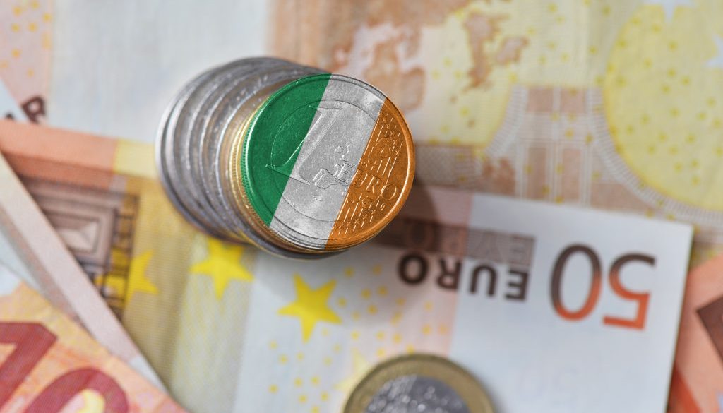 euro coin with national flag of ireland on the euro money banknotes background.