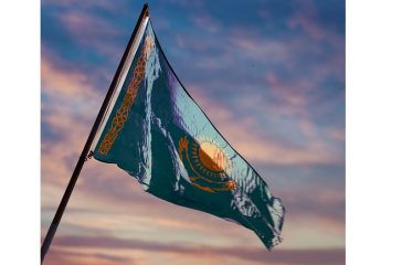 Kazakhstan flag, Kazakh flag waving on sky at dusk