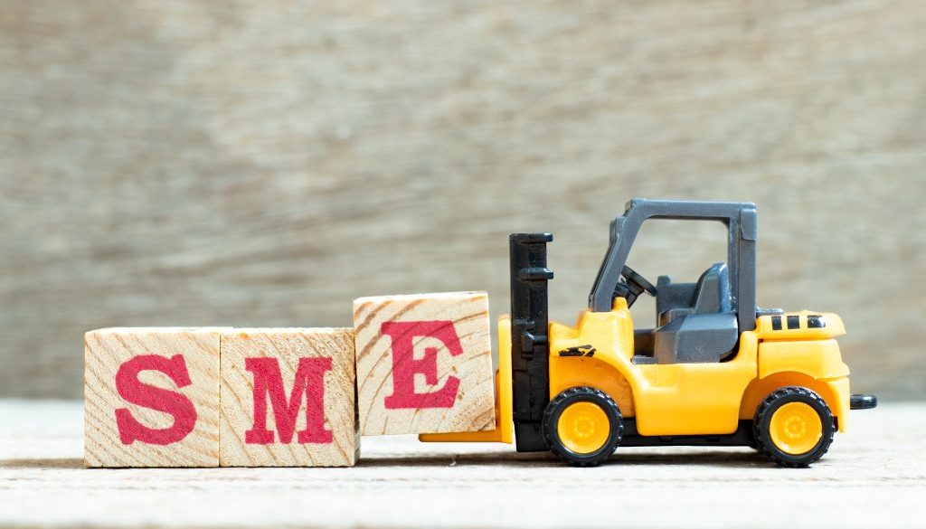 Toy forklift hold letter block e to complete word SME (abbreviat